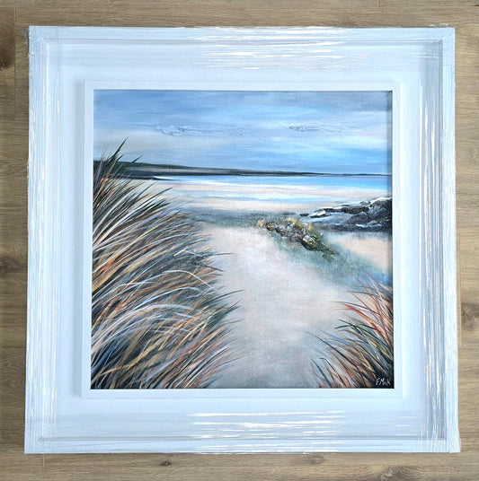 Framed painting of a beach scene with grasses in the foreground