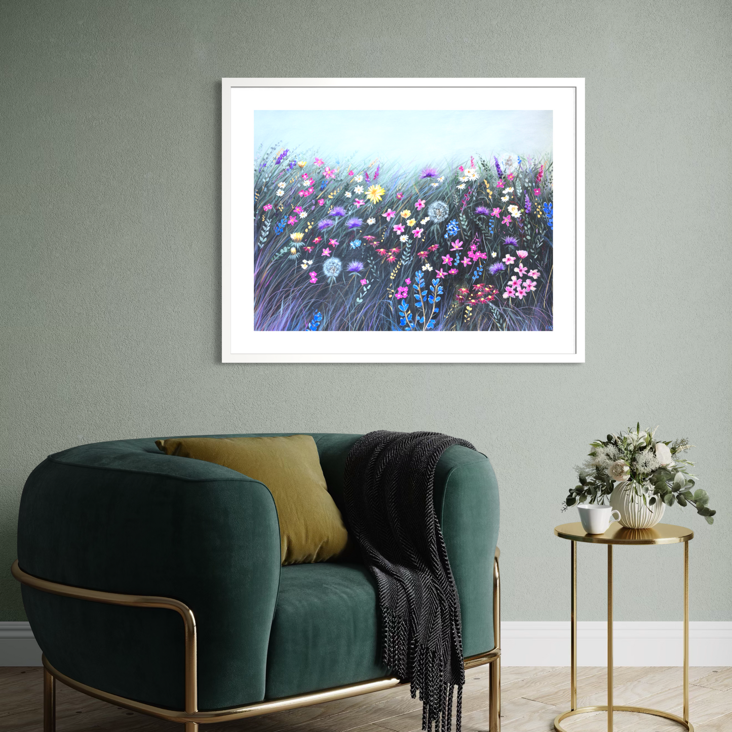 Framed floral artwork above a green sofa in a living room.