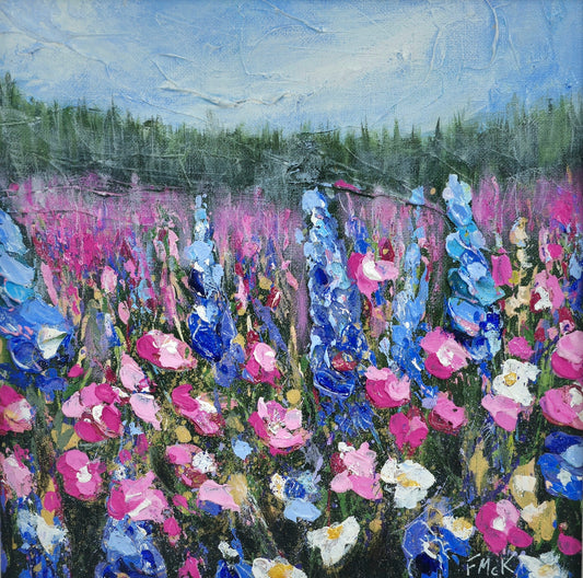 Original acrylic painting of a colorful field of wildflowers with a bright blue sky, framed in a light wood frame.