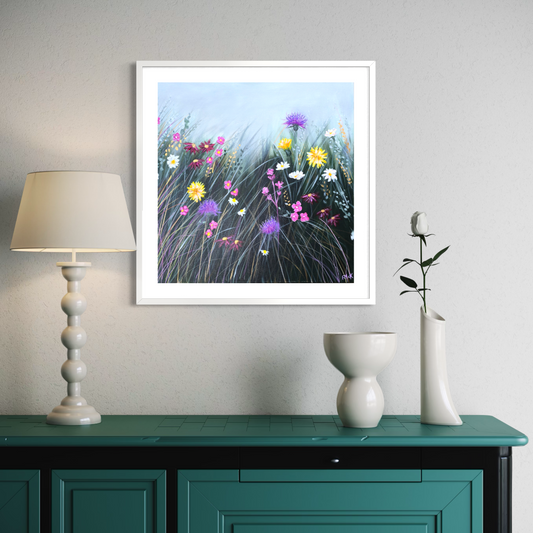 Framed artwork of flowers on a wall above a green table