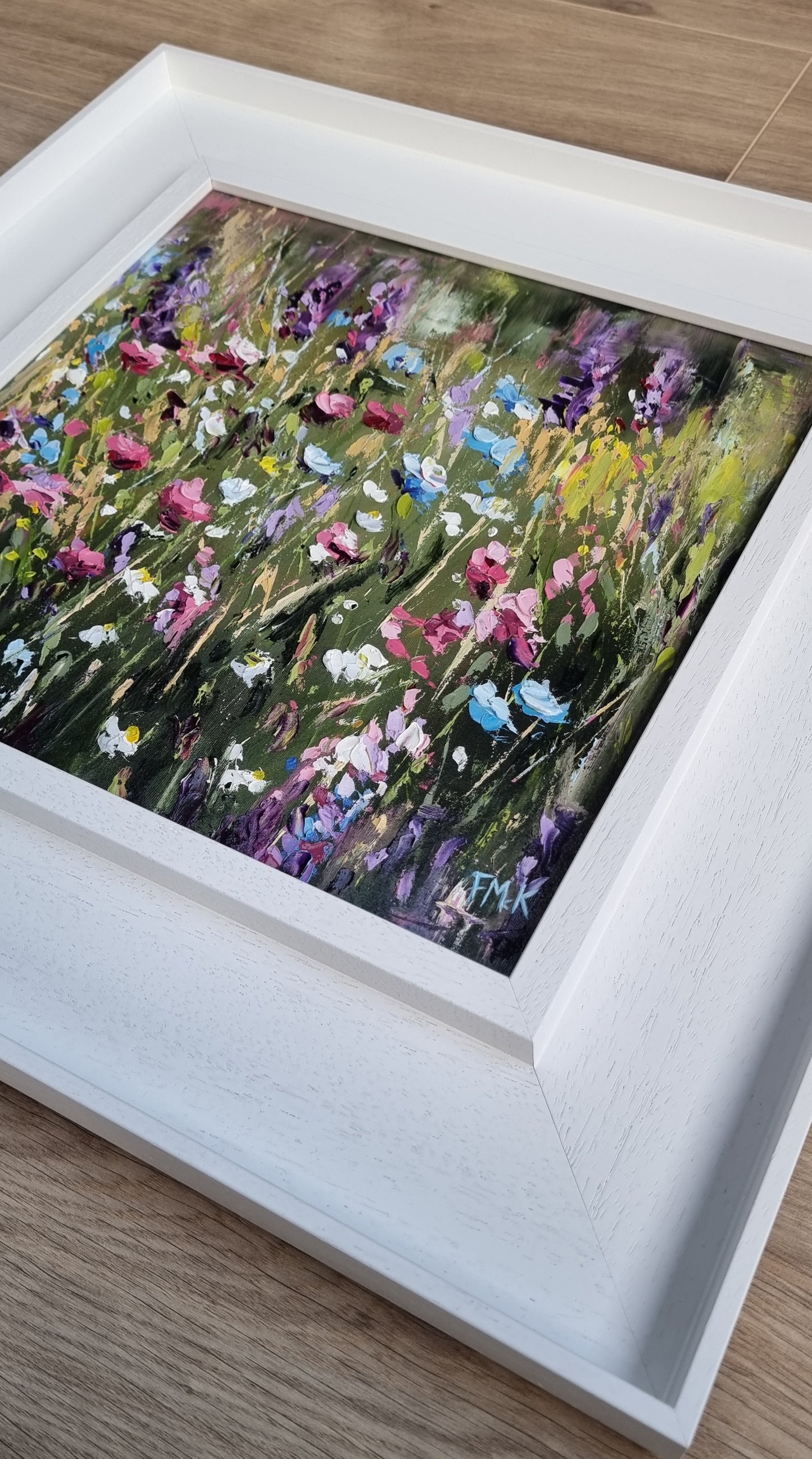 An original floral oil painting of flowers on a woodland walk. The colours are bright, positive and joyful.