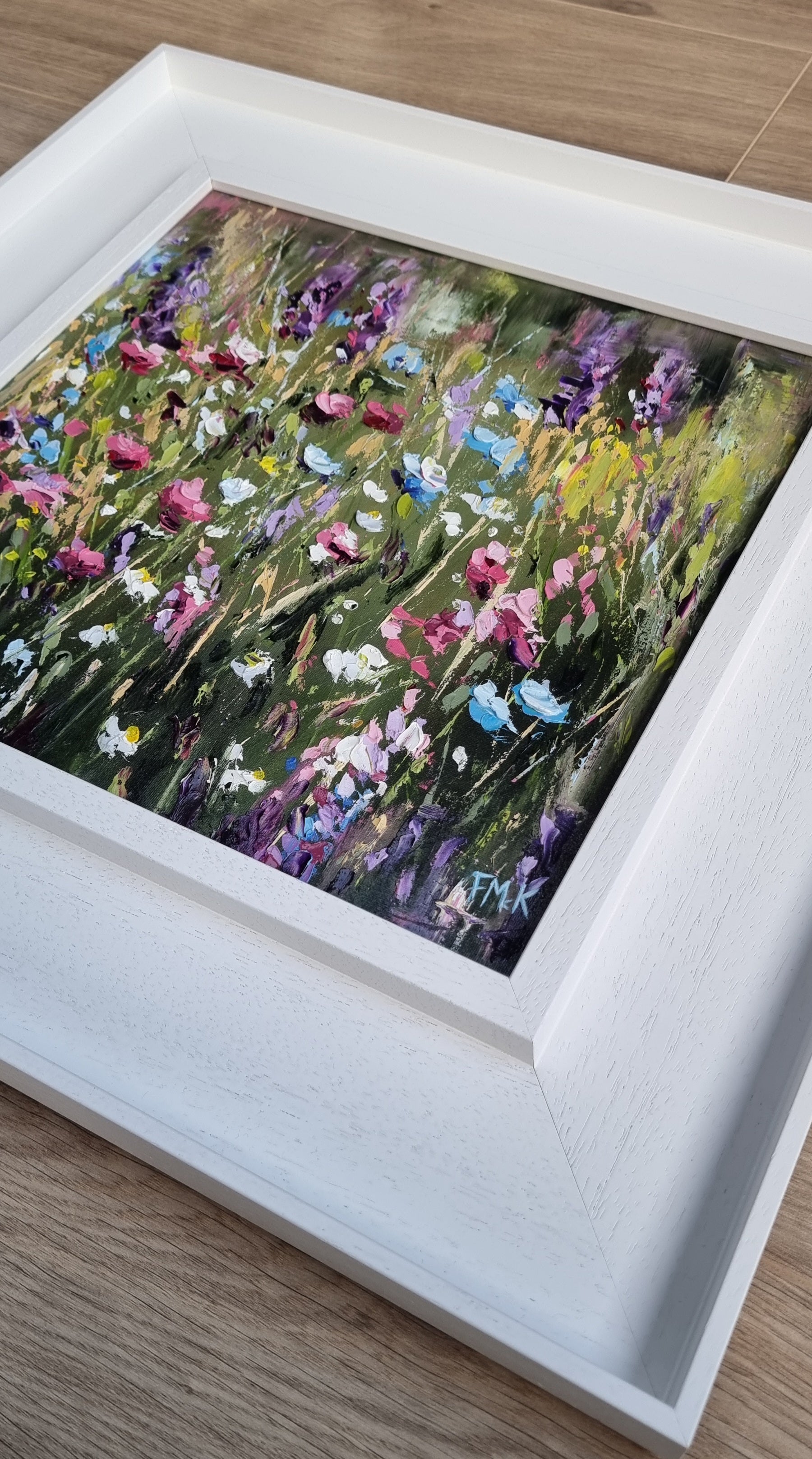An original floral oil painting of flowers on a woodland walk. The colours are bright, positive and joyful.