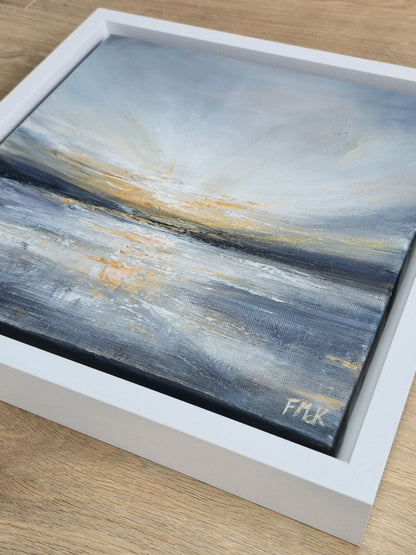 Abstract painting with blue and gold tones in a white frame