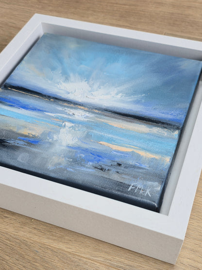 Framed painting of a coastal scene