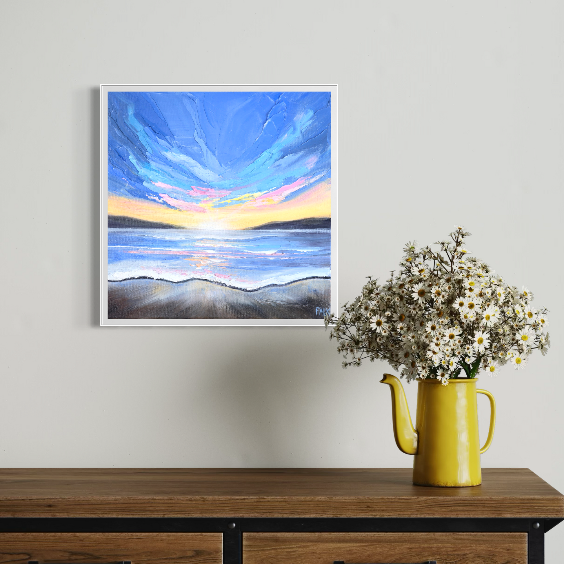 Framed abstract painting on a wall above a wooden table
