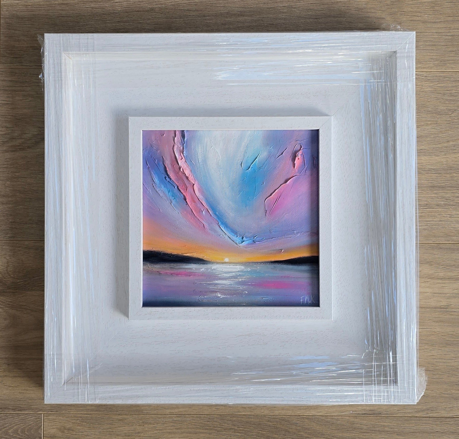 Framed abstract painting with sunset colours