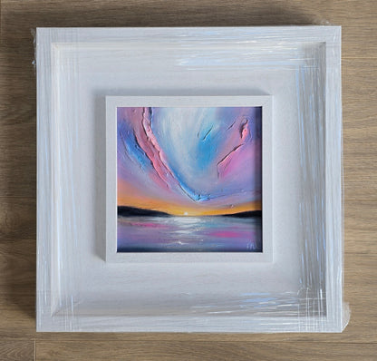 Framed abstract painting with sunset colours