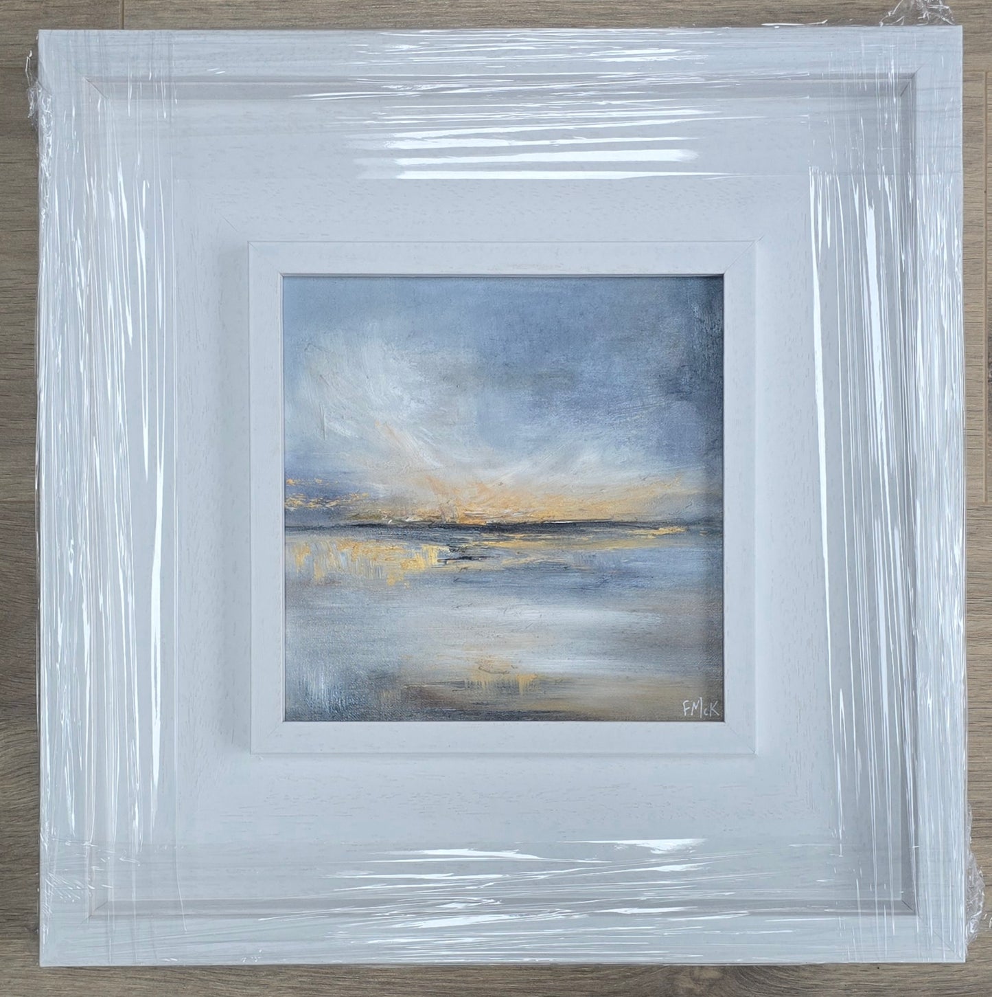 Framed painting with a white border