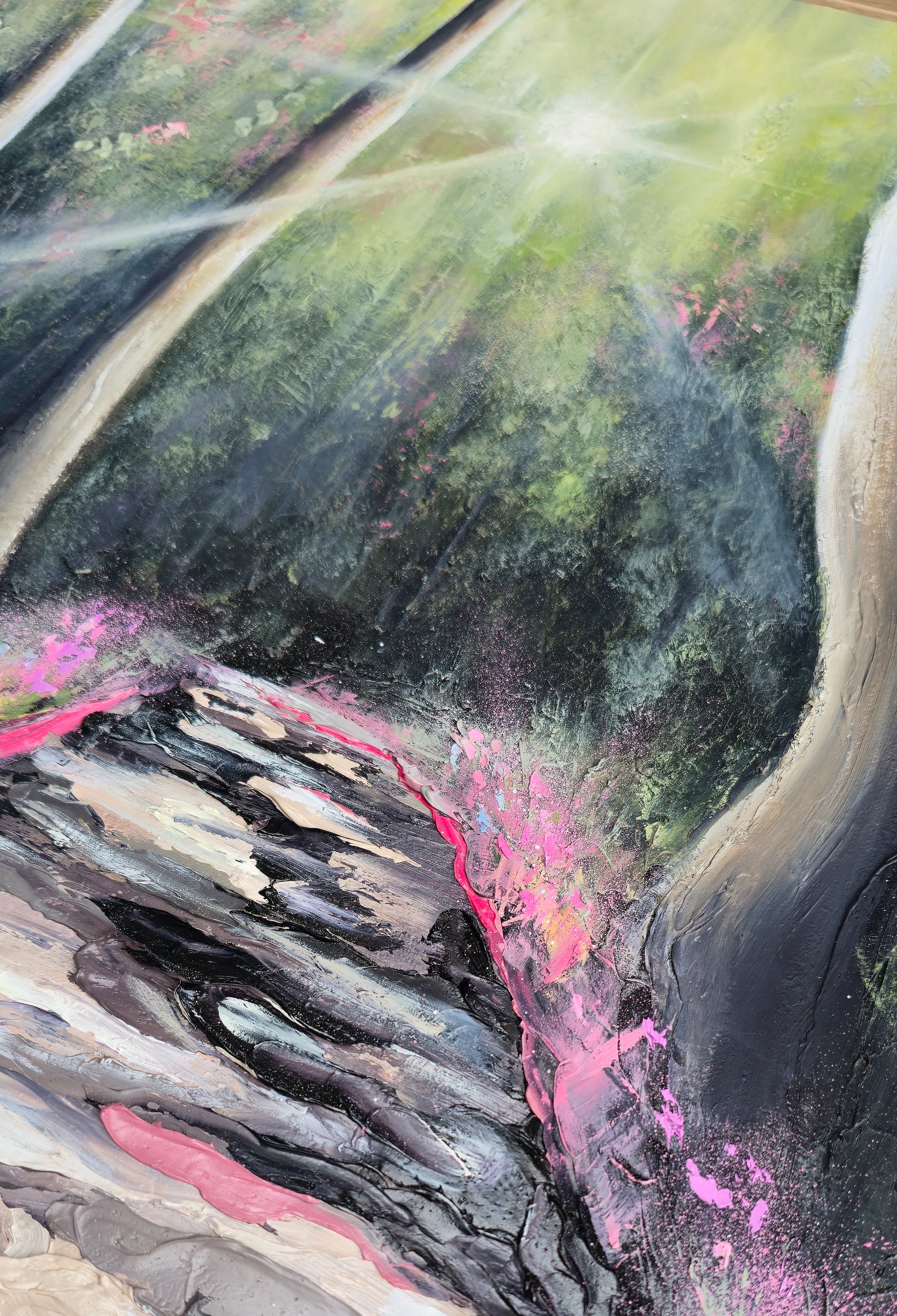 Close-up of a textured surface with pink, black, and green colors