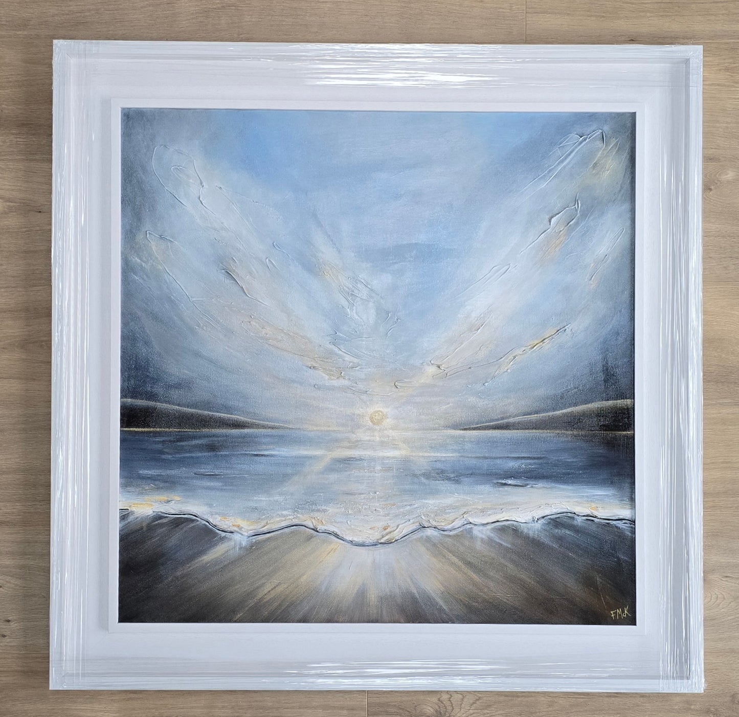 Framed painting of a landscape with reflective water and sky.