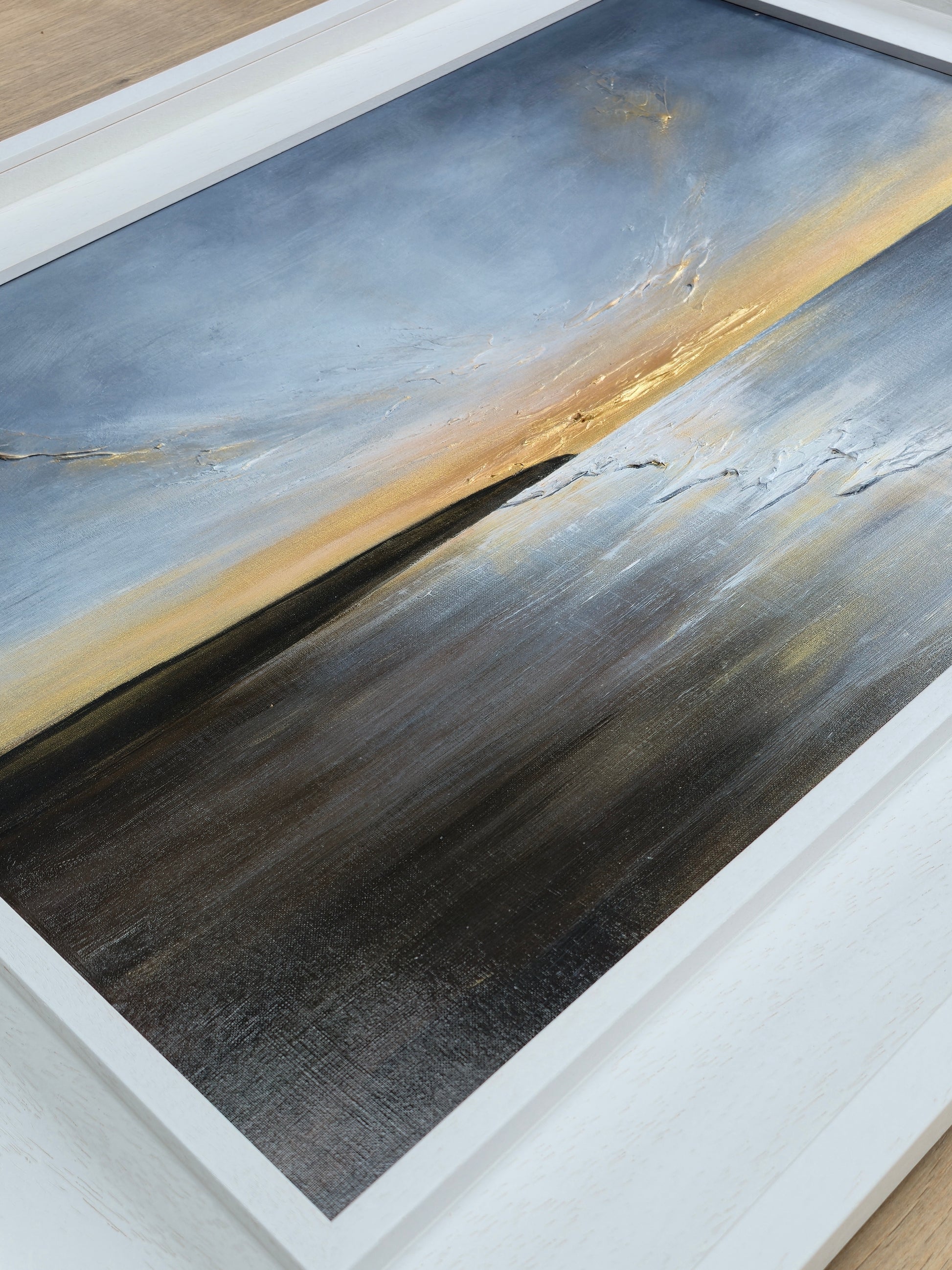 Abstract art piece with gold and gray colors on a white frame