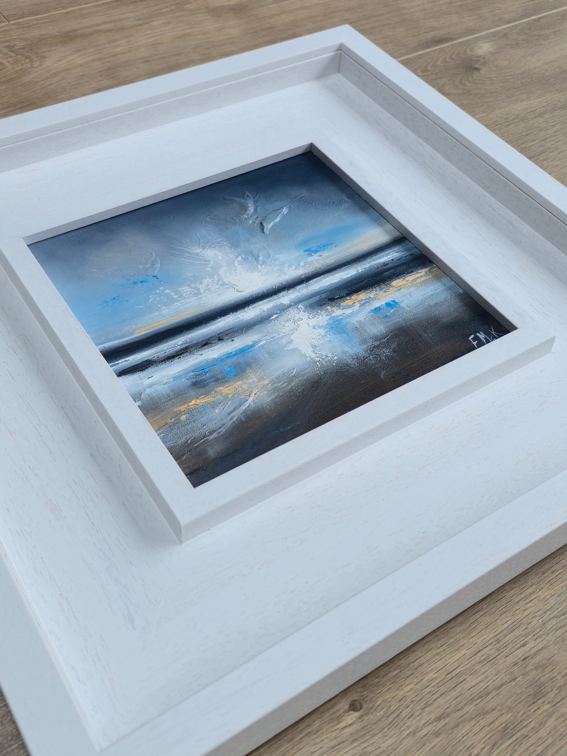 Framed abstract coastal painting