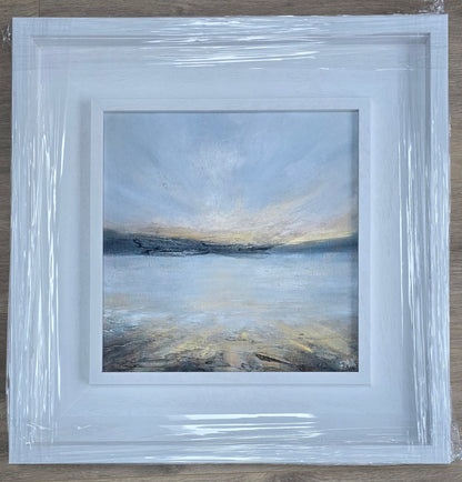 Framed abstract painting with a blue and gray color scheme on a wooden surface