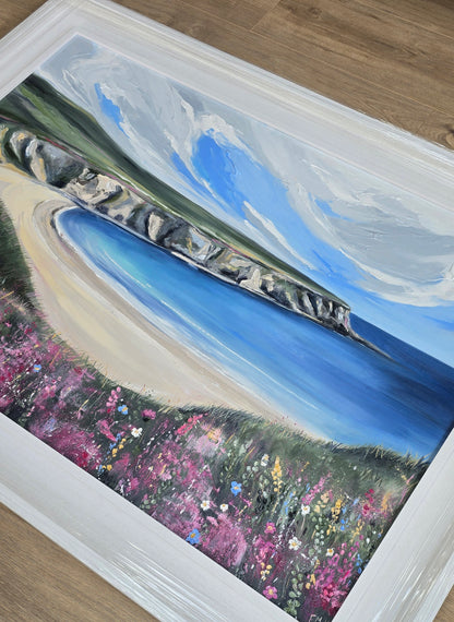 Framed artwork of a coastal Donegal scene with flowers.