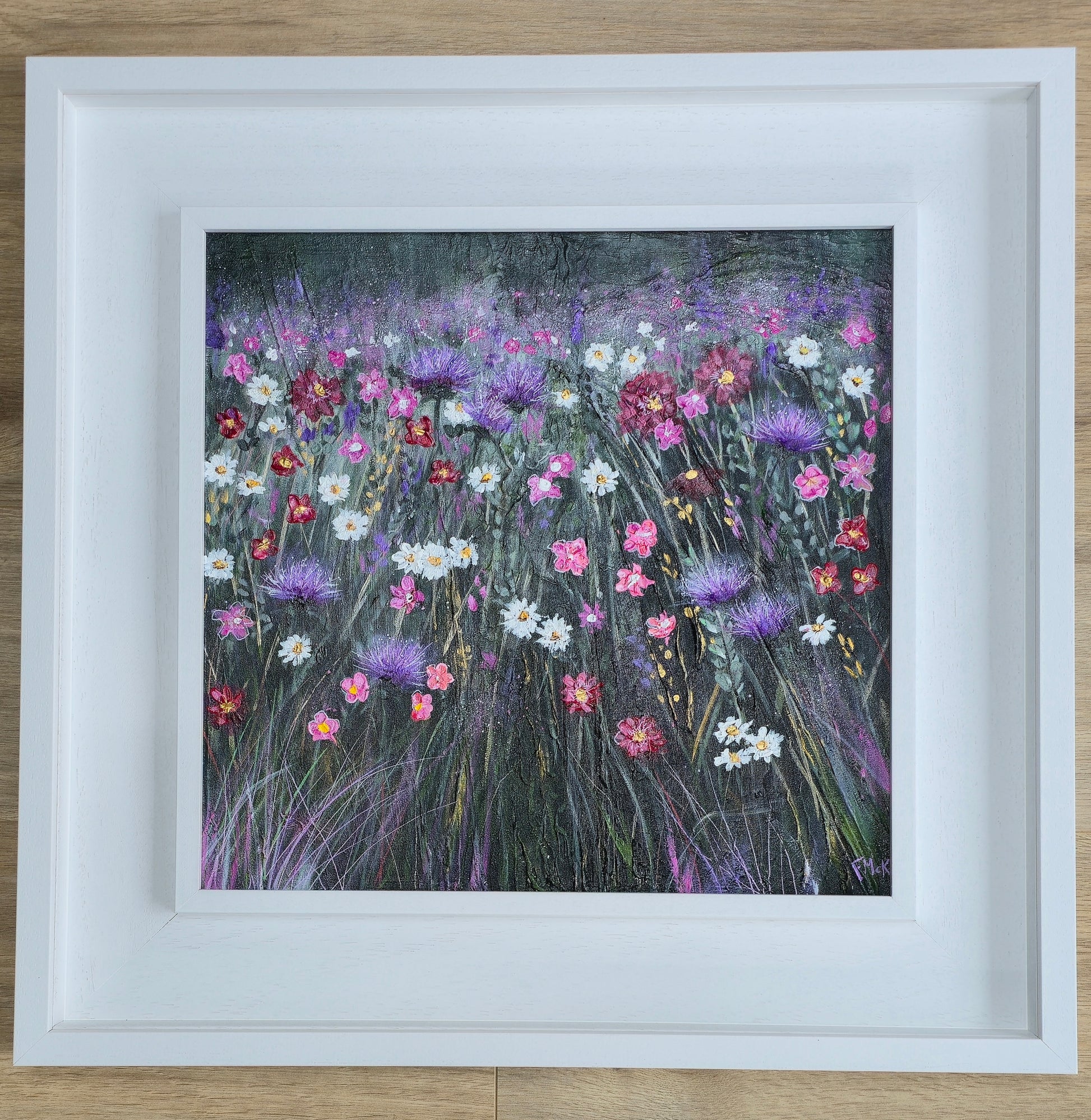 Framed artwork of a colourful floral field