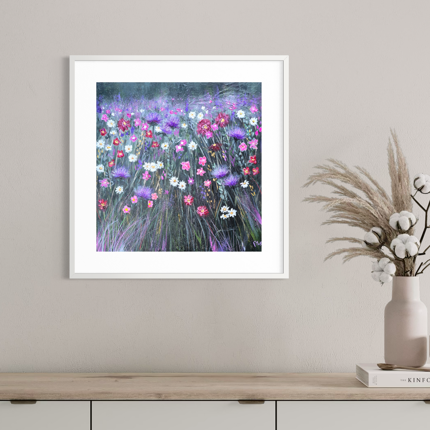 Framed artwork of a colourful floral painting on a wall