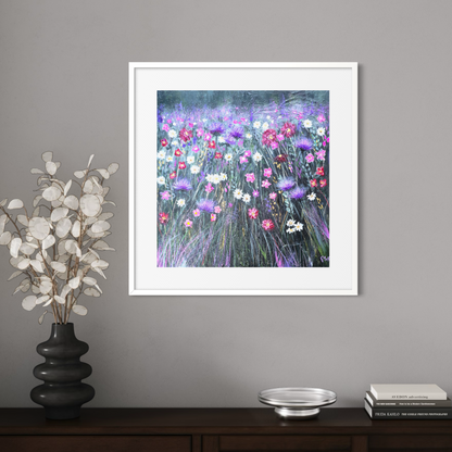Framed floral artwork on a gray wall with decorative items below.