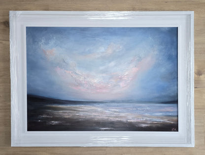 Framed painting of a landscape with a blue sky, pink clouds and water.