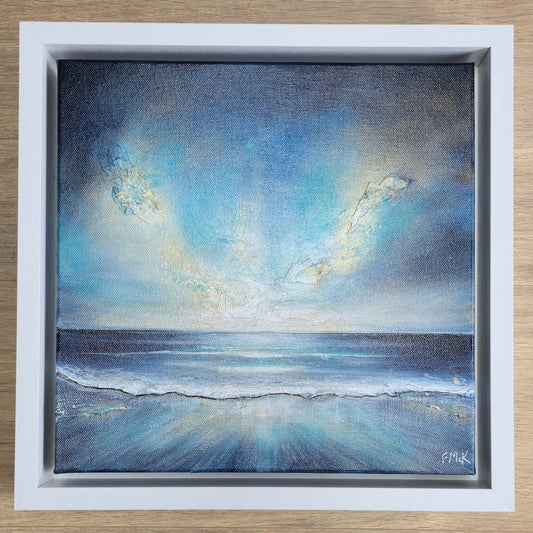 Framed painting of a serene seascape with blue sky and clouds.