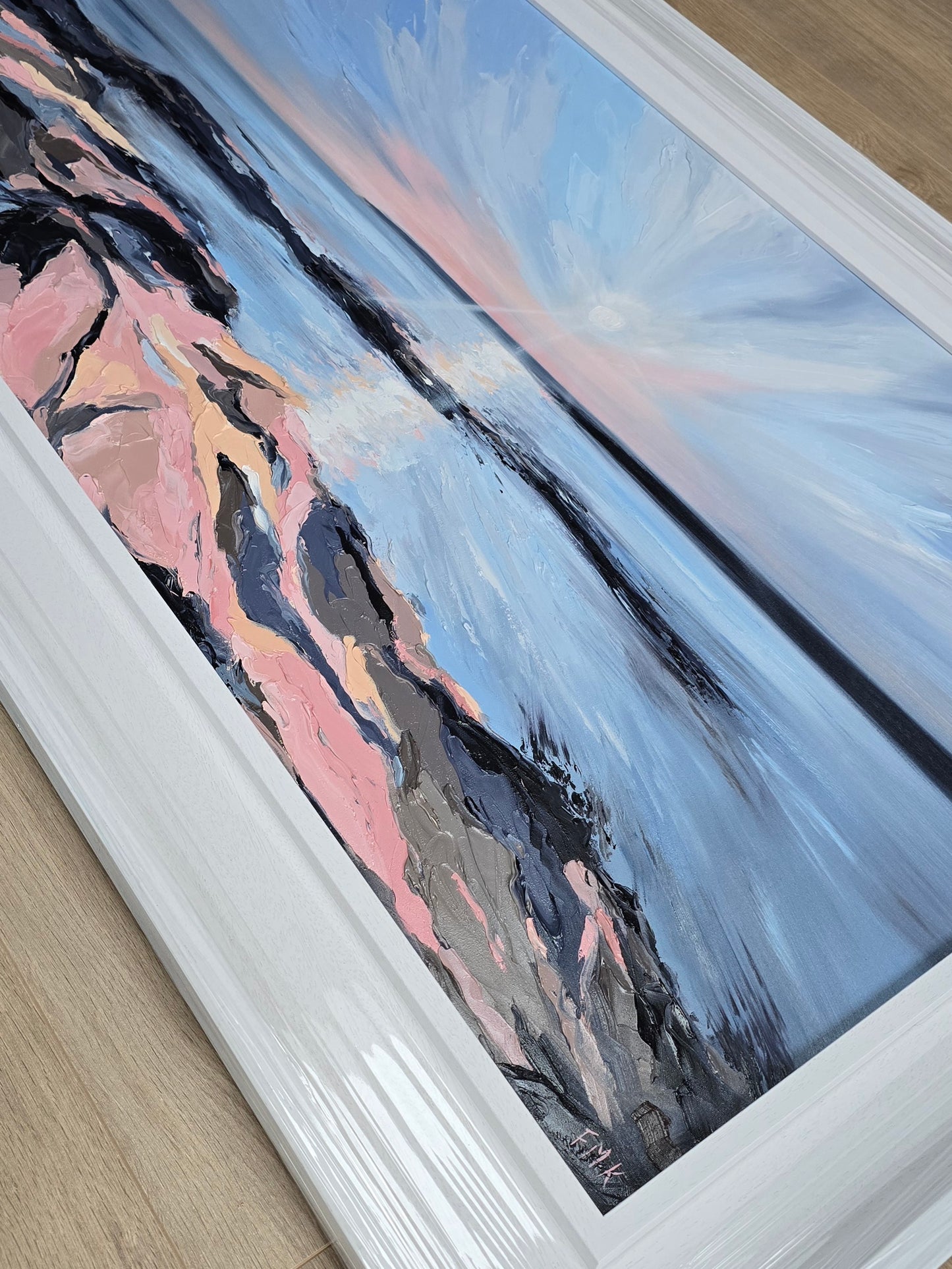 Framed abstract painting with a white frame