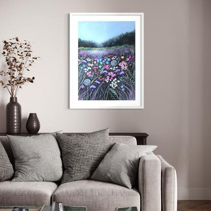 Framed artwork of a floral landscape above a sofa in a living room.