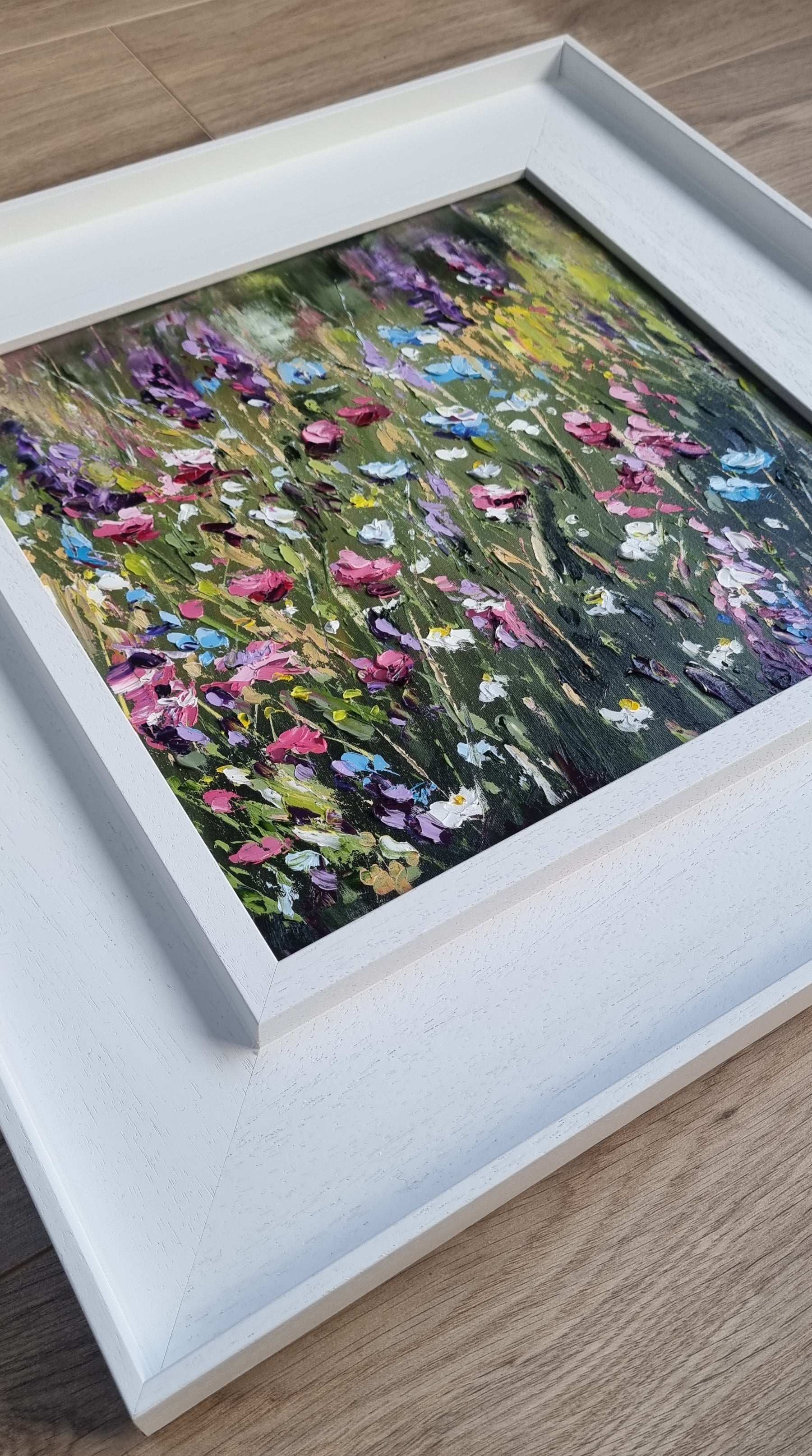 An original floral oil painting of flowers on a woodland walk. The colours are bright, positive and joyful.