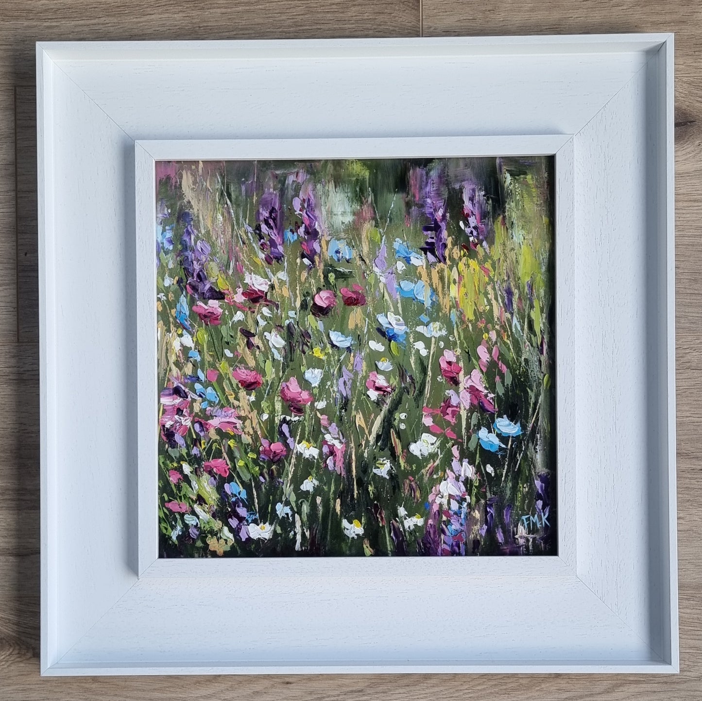 An original floral oil painting of flowers on a woodland walk. The colours are bright, positive and joyful.